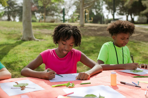 Children drawing in a park
